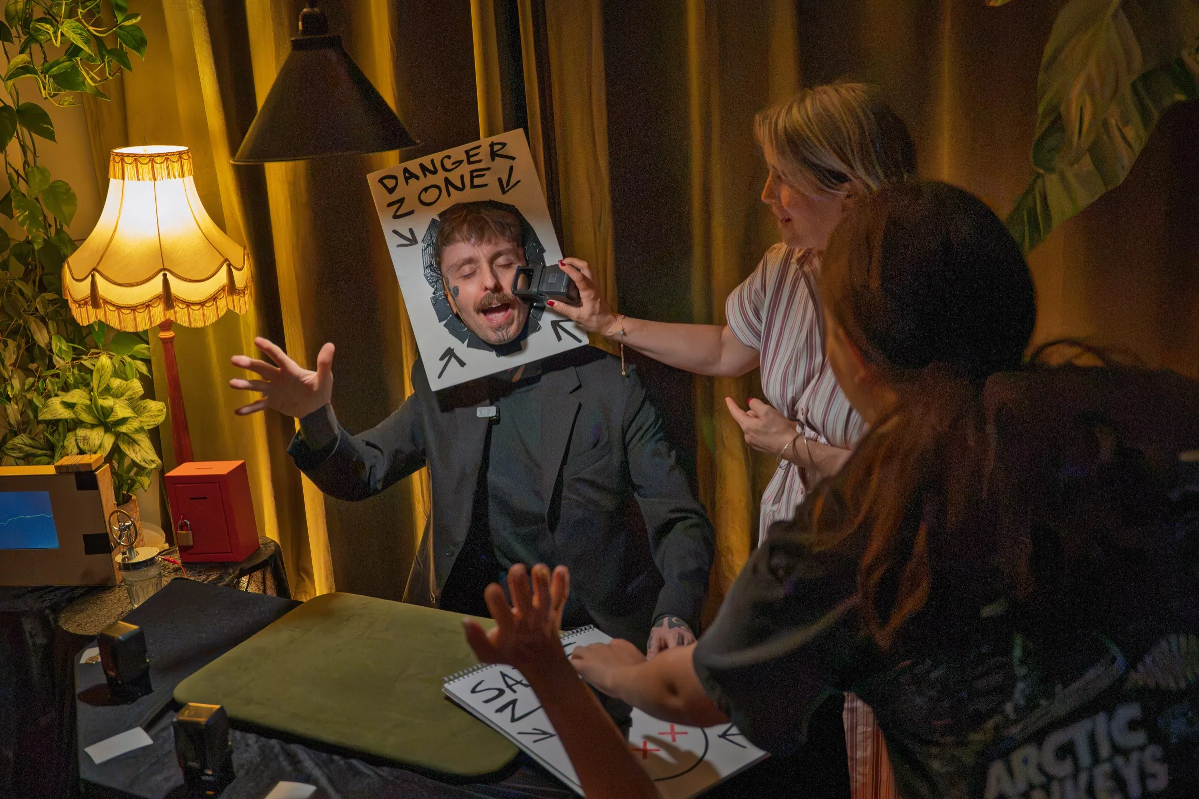 Two guests mid-routine with the DANGER ZONE sign at Bristol Magic Theatre