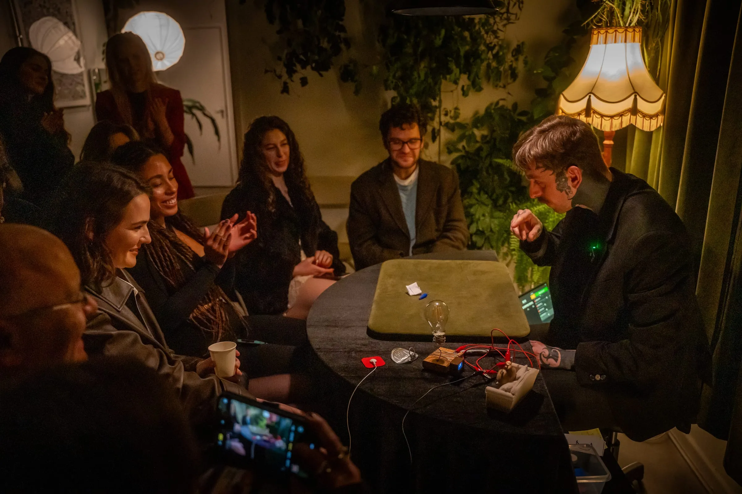 Audience reacting with delight around the table at Bristol Magic Theatre