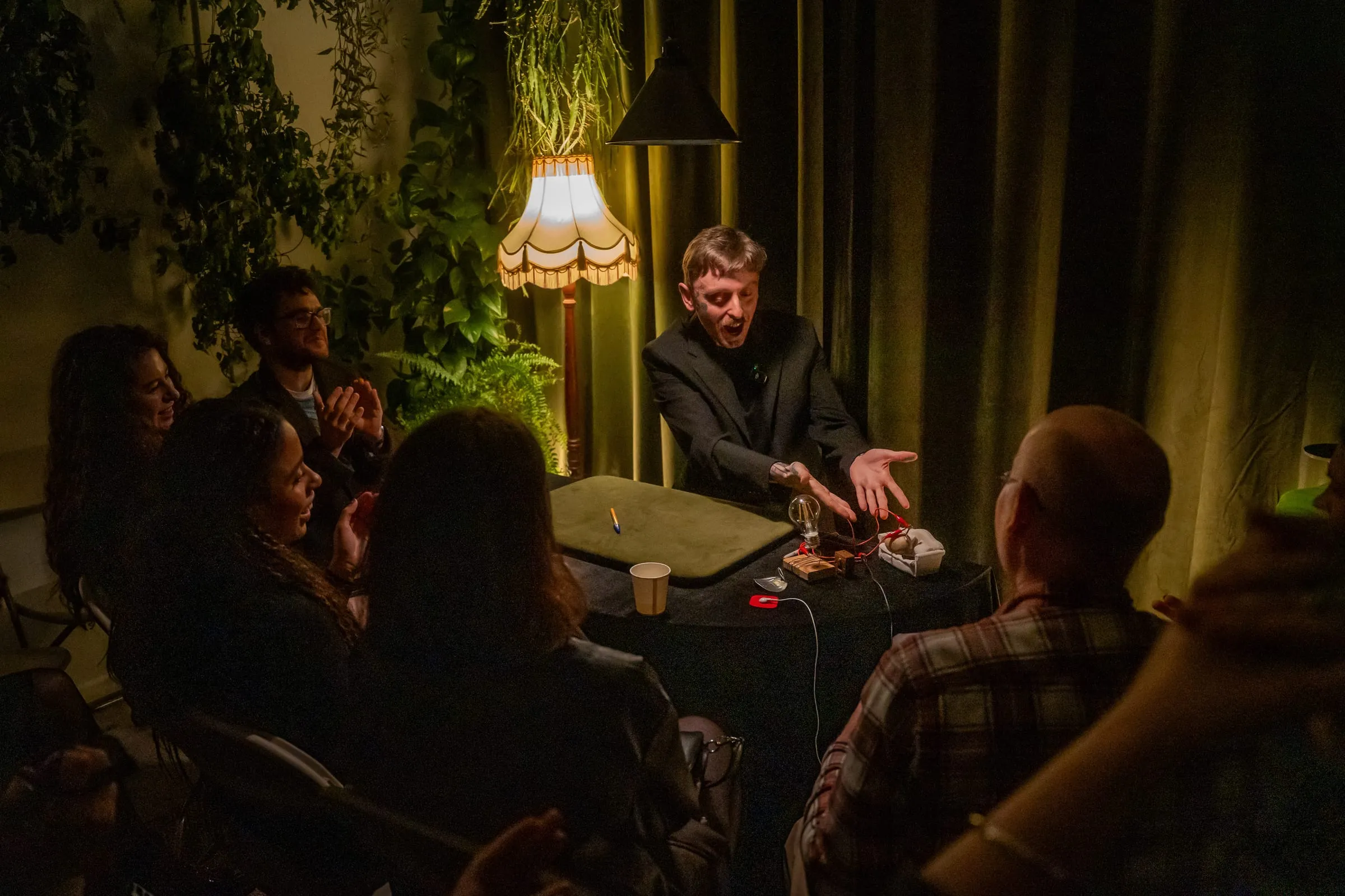 Guests laughing and gasping during a close-up magic show